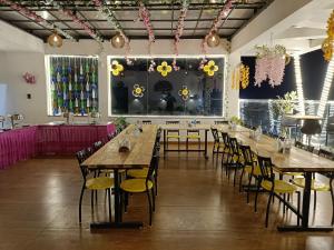 a row of tables and chairs in a room with flowers on the wall at Hotel Imperial Crown in Rewāri