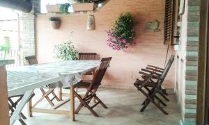 einen Tisch und Stühle auf einer Terrasse mit Blumen in der Unterkunft La Terrazza Fiorita in Nebida