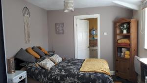 a bedroom with a bed and a couch at Thyme Cottage in Whitby