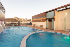 a large swimming pool in front of a building at فندق لوريف in Taif