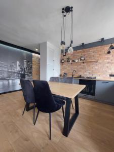 a dining room with a wooden table and chairs at FRIENDS House in Gorzów Wielkopolski
