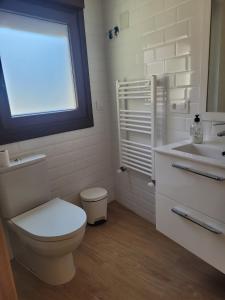 a bathroom with a toilet and a sink and a window at Casa do Porto in Partovia +77 photos