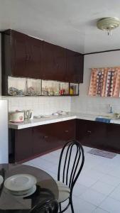 a kitchen with a table and a table and chairs at Dion's Place in Iloilo City