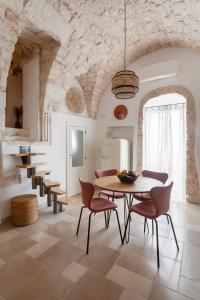 a dining room with a table and chairs at Casa Antica Pietra Ostuni in Ostuni