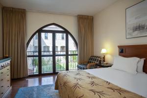 a hotel room with a bed and a large window at Ruth Safed By Dan Hotels in Safed