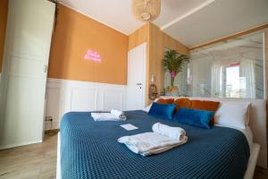 a bedroom with a bed with two towels on it at Finestra sulla Sicilia in Catania