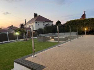 a park with a row of poles in the grass at Lovely 3 bedroom home in Rhos on Sea in Llandrillo-yn-Rhôs