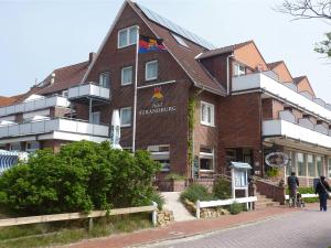 a building with a sign on the side of it at Hotel Strandburg in Baltrum