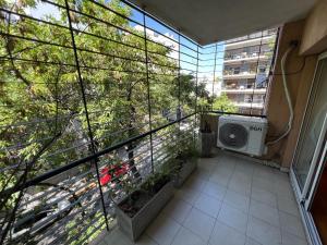 a room with a balcony with a washing machine at Amplio 2 ambientes en Belgrano! Gran ubicación! in Buenos Aires