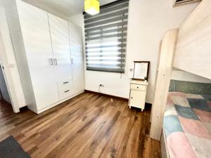 a bedroom with a bed and a dresser and a window at Like at home near Seville in Dos Hermanas