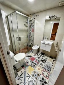a bathroom with a toilet and a sink and a shower at Like at home near Seville in Dos Hermanas +16 photos