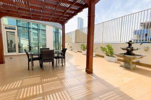 a patio with a table and chairs on a building at Veluxa - Large and Stylish 1 Bed in JLT! in Dubai