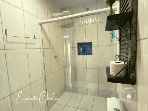 a bathroom with a shower with a glass door at Encanto Chalés – 150m da Praia Grande – Penha – SC in Penha +83 photos
