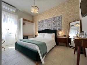 a bedroom with a large bed and a mirror at Incanto Siciliano in Noto