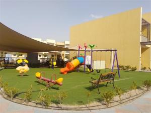 a playground in a building with a park with a slide at Spacious 3BR Townhouse Villa in Dubai