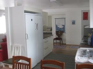 a kitchen with a white refrigerator in a room at Huoneistomajoitus Hella 3C Härmä in Härmä