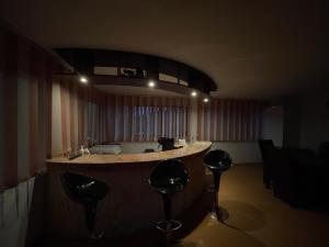 a bar in a room with stools at a counter at Casa Alleria in 2 Mai
