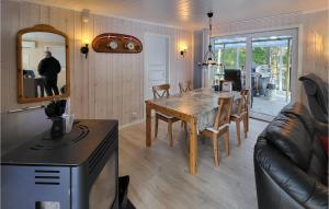 a living room with a wooden table and a dining room at Nice Home In Rde With 2 Bedrooms in Råde