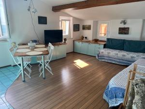 a living room with a table and a couch at Elegant apartment with sea view in Monterosso al Mare