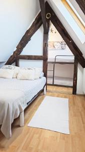a bedroom with a bed and a white rug at Appartement Saint Malo vue sur mer et sur intra muros, Ferry, plage et commerces à 50 m in Saint Malo