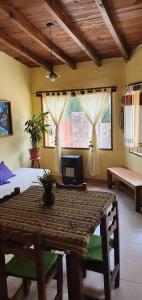 a bedroom with a table and a bed and a window at La Casa de la Abuela Tilcara in Tilcara