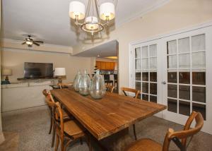 a dining room table with four glass vases on it at Oasis at Orange Beach 1103 in Orange Beach