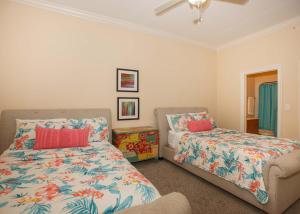 a bedroom with two beds and a couch and a fan at Oasis at Orange Beach 1103 in Orange Beach +38 photos
