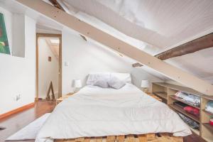 a bedroom with a large bed in a attic at Casa Seta - La Candelaria in Bogotá