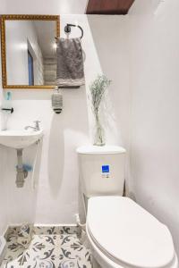 a bathroom with a toilet and a sink at Casa Seta - La Candelaria in Bogotá