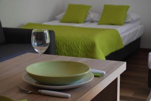 a table with a bowl and a glass of wine at Villa Veell - tylko 4 minuty od pięknej szerokiej plaży in Pobierowo