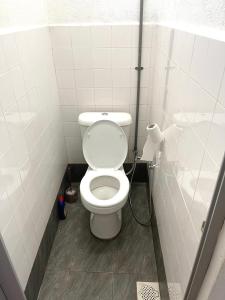 a bathroom with a white toilet in a stall at Home33#2pax#wifi&netflix#NearAeonAlma#5kmIconCity#5kmtoSimpangAmpat in Bukit Mertajam