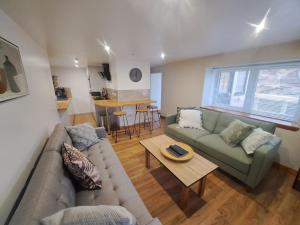 a living room with a couch and a table at NC500 - Modern croft house at Handa HI-00734-F in Scourie
