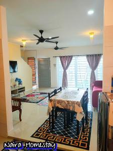 a living room with a table and a ceiling fan at Naira Homestay Kota Bharu ,Wakaf Che Yeh 4 Bilik 3 Aircond in Kota Bharu