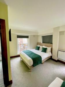 a bedroom with a large bed and a window at The Norseman Temple Bar in Dublin