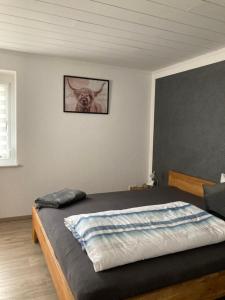 1 dormitorio con 1 cama con una foto de un perro en la pared en Ferienwohnung Petra en Rust