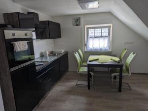 a kitchen with a table and chairs and a small table with a table at Haus Margarete in Warstein