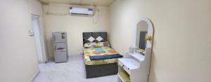 een kleine kamer met een bed en een wastafel bij Abdullah Kamber Building in Dubai