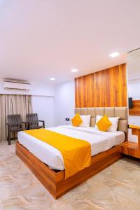 a bedroom with a large bed with yellow pillows at CALANGUTE CASTLE in Bardez