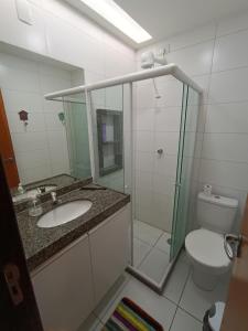 a bathroom with a shower and a sink and a toilet at Flat Monte Castelo Gravatá in Gravatá