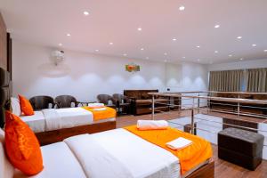 a room with three beds and a table and chairs at CALANGUTE CASTLE in Bardez