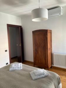 a bedroom with a bed and a wooden cabinet at H2Ome Il Cembalo in Genoa
