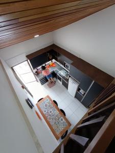 an overhead view of a kitchen with a table and chairs at Flat Monte Castelo Gravatá in Gravatá