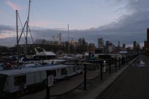 a group of boats docked in a harbor with a city at Transom Close in London