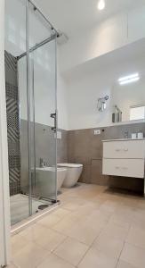 a bathroom with a shower and a tub and a sink at BARBARA Classy Apartment 101 in Siracusa