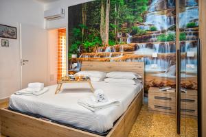 a bedroom with a bed with a waterfall mural on the wall at B&B-Apartment-Sleeps3-Parking-Balcony-PetFriendly in Sorrento