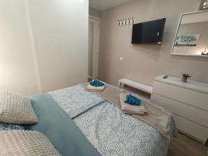 a bedroom with a bed with towels on it at Apartamento de Colón in Gijón