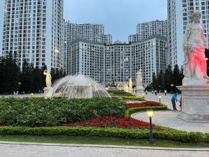 a fountain in a park in front of tall buildings at Vinhomes Royal City Luxury Apartment 2 Br in Hanoi