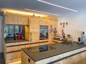 a kitchen with wooden walls and a counter top at Risa in Arosa