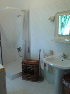 a bathroom with a sink and a shower and a toilet at Rocca tagliata Marsala in Marsala +33 photos