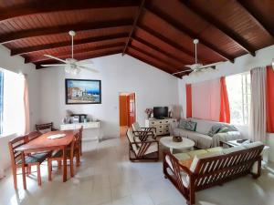 a living room with a couch and a table at Kismet Garden Cottages - Dover Beach in Christ Church